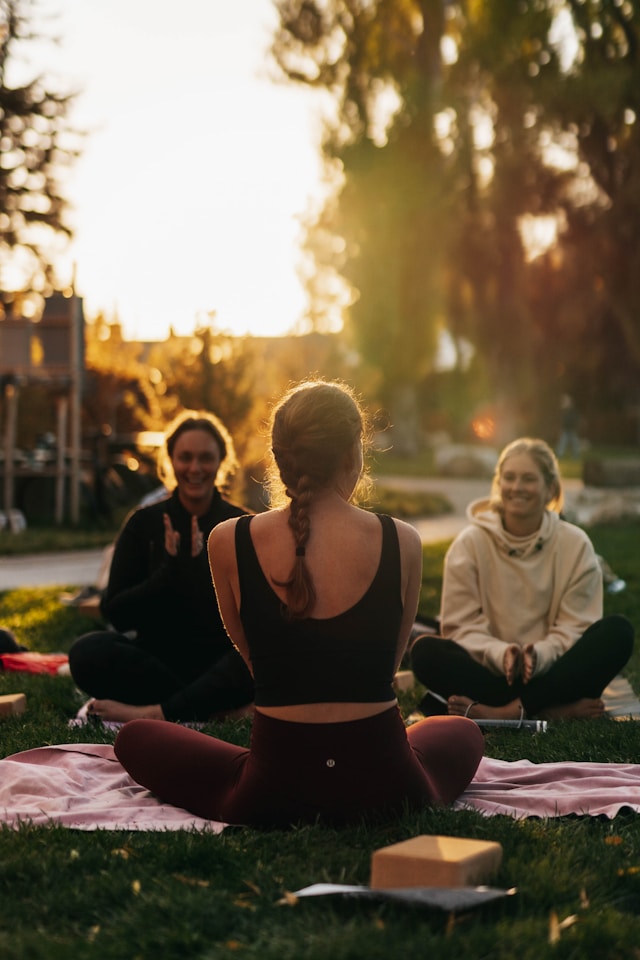 Yoga session in the park at sunset