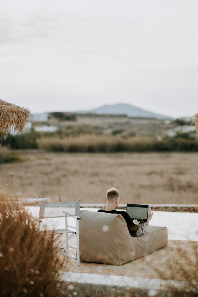 Man working on a laptop in an outdoor setting